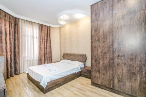 a room with a bed and a large wooden wall at Magnificent Vacation apartment by Bea Paradise in Baku