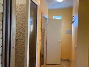 a bathroom with a shower and a glass door at Pirts cottage in Kaltene +30 photos