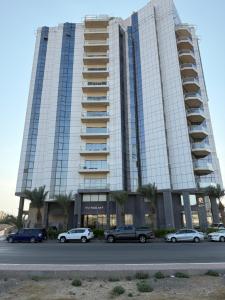 a large building with cars parked in front of it at أبحر ريزيدينس804 in Obhor