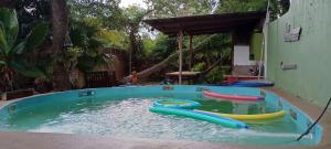 a pool of water with three boats in it at Aloha hospedaje in Puerto Iguazú