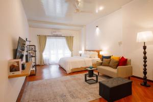 a living room with a bed and a couch and a room at CBD Studio2 at Next to Sun Plaza Mall! in Medan