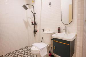 a bathroom with a toilet and a sink and a shower at CBD Studio2 at Next to Sun Plaza Mall! in Medan +19 photos