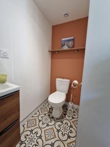 a bathroom with a toilet and a sink at La Maisonette in Plounevez-Moëdec