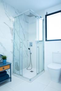 a glass shower in a bathroom with a toilet at New apartment with 80m2 garden close to Torrevieja Alicante in San Miguel de Salinas