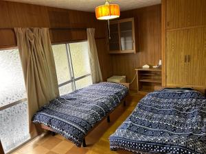 A bed or beds in a room at ポートサイドSasebo藤原町
