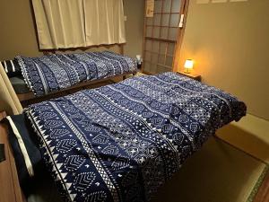 A bed or beds in a room at ポートサイドSasebo藤原町