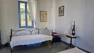 a bedroom with a bed and a window and a table at Sea House in Galaxidi