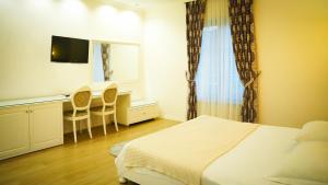Postel nebo postele na pokoji v ubytování Garden Hotel