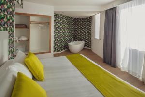 a living room with a white couch and a bath tub at Flamingo Beach Mate in Adeje