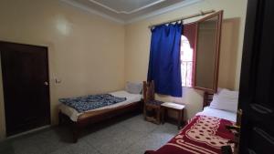 Postel nebo postele na pokoji v ubytování hôtel oasis tinghir