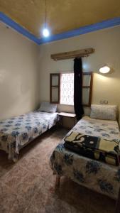 Postel nebo postele na pokoji v ubytování hôtel oasis tinghir