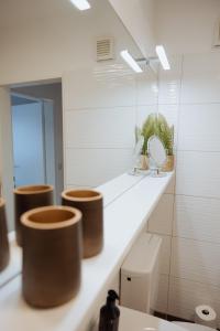 a bathroom with three toilets and a mirror at Stadtjuwel I Balkon I 6 Min zum See in Gunzenhausen +20 photos
