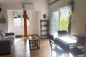 a living room with a couch and a table at Maisonnette au pied des Pyrénées in Nestier