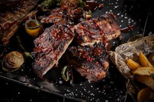 a plate of meat and vegetables on a table at Hotel Astoria Playa Adults Only 4* Sup in Port d'Alcudia