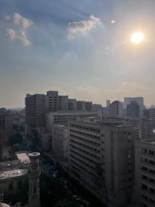 a view of a city with the sun in the sky at Heaven Hostel in Cairo