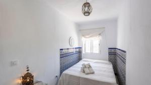 a white room with a bed and a window at Chalet El Nido Níjar by Ruralidays in Níjar