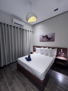 a bedroom with a large white bed with white pillows at Heaven Hostel in Cairo