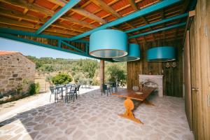 a kitchen and dining room with blue chandeliers at Casa do Marujo e Casa do Mirone in Fornos de Algodres