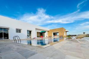 a swimming pool in the backyard of a house at Riverside 3BR Farm - Pool & Stunning Views in Oulad Yakoub