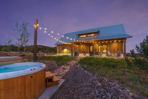 a house with a hot tub in the yard at Rocking M Ranch in South Fork, CO in South Fork
