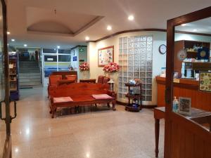 a store with a bench in the middle of a room at SP Residence in Nakhon Phanom