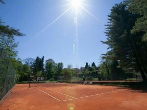 einen Tennisplatz, auf dem die Sonne scheint in der Unterkunft Riva Del Caolino - Happy Rentals in Ispra