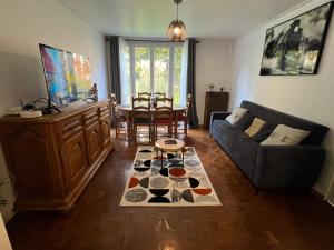 a living room with a couch and a table at Champions Deluxe in Sarcelles