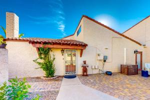 a white house with a door and a fire hydrant at Sunset Lane in Tempe