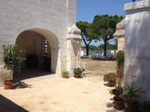 an entrance to a building with potted plants at Masseria Purgatorio in Fasano