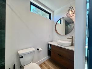 a bathroom with a toilet and a sink and a mirror at Star Gazer in Orderville