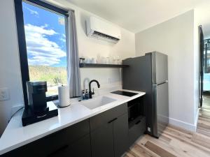 a kitchen with a sink and a refrigerator at Star Gazer in Orderville