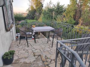 a stone patio with a table and chairs on a balcony at Studio avec chambre Camargue in Arles