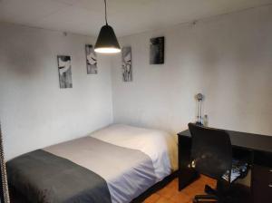 a bedroom with a bed and a desk and a chair at Studio avec chambre Camargue in Arles