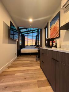 a room with a kitchen with a bed in the background at Valley View in Orderville