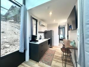 a kitchen with a sink and a refrigerator and a table at Red Hollow in Orderville