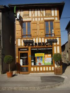 a store front of a wooden building with windows at Chambres d'hôtes Le Gilliard in Chavanges