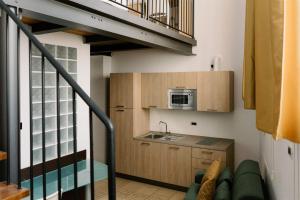 a small kitchen with a sink and a microwave at Residence Carlton in Ferrara