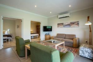 a living room with a couch and a table at Raptor Rise Farm in Tulbagh