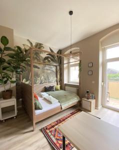a bedroom with a bed and a large painting on the wall at K2-Project - Dschungel-Abenteuer in Chemnitz