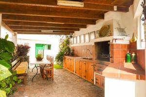 a kitchen with a sink and a table in a room at Casa La Poyata - Taganana in Santa Cruz de Tenerife +57 photos