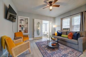 a living room with a couch and a table at Stylish home Garage Walk to Lake Minutes from Airport in Saint Francis