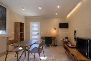 a living room with a table and a tv at Il Corridore - Locanda Bistrò in Felegara