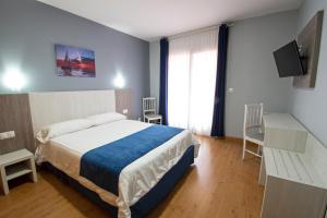 Posteľ alebo postele v izbe v ubytovaní Hotel Campomar