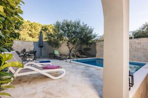 a patio with chairs and a swimming pool at Pietro in Korčula