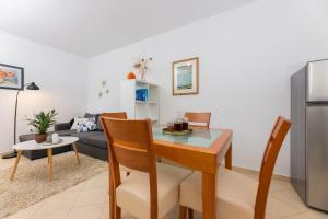a kitchen and living room with a table and a couch at Pietro in Korčula