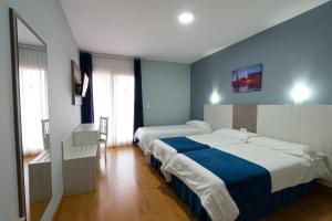 Posteľ alebo postele v izbe v ubytovaní Hotel Campomar