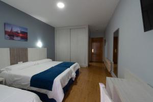 Posteľ alebo postele v izbe v ubytovaní Hotel Campomar