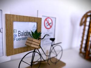 a bike with a plant in a box on a table at El Balcón de Fuenteheridos in Fuenteheridos