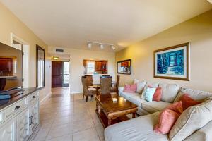 a living room with a couch and a table at BeauMer 102B in Naples