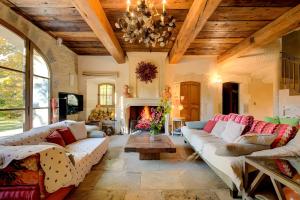 a living room with couches and a fireplace at Mas Des Cigales Lambesc in Lambesc